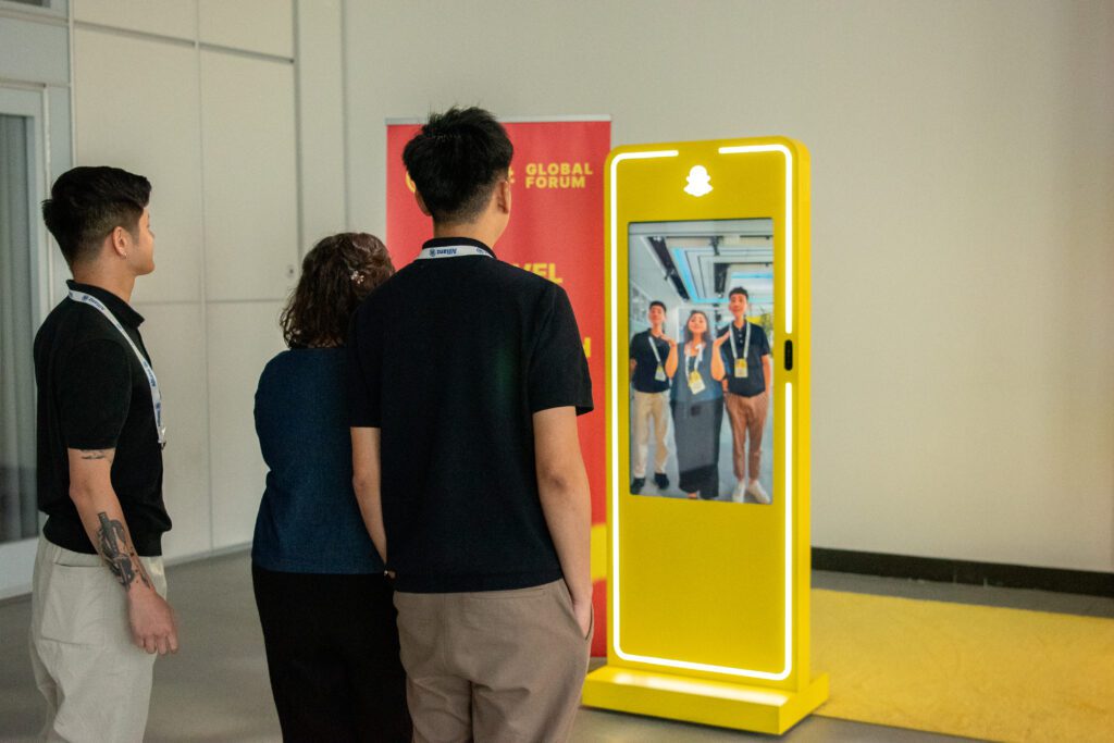 Attendees interacting with Snapchat activation at Skift Global Forum 2024